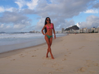 Girl model in bikini with long black hair on the Copacabana beach, Rio de Janeiro, Brazil