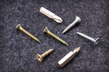 Fixing screws and bits on a black background