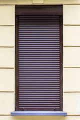Window with closed shutters. Lockdown period.