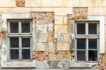 Fototapeta na wymiar Vintage windows in wooden frame on a grunge damaged wall.