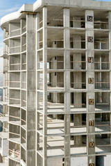 Aerial view of concrete frame of tall apartment building under construction in a city