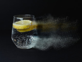 Glass with lemonade disintegration. Abstract concept