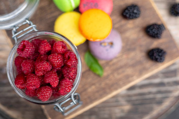macaroons with berries on a wooden table