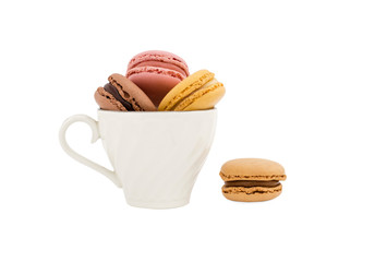 Macaroons in a cup and a light brown macaroon