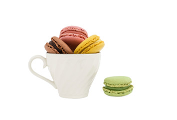 Macaroons in a cup and a green macaroon