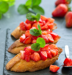 Bruschetta with strawberries and basil. Selective focus