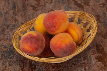 Peach heap in the wooden basket