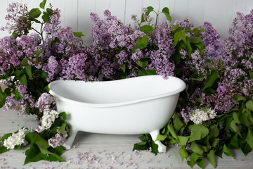 Fototapeta na wymiar photo zone for a photo shoot with lilac. bath with purple flowers