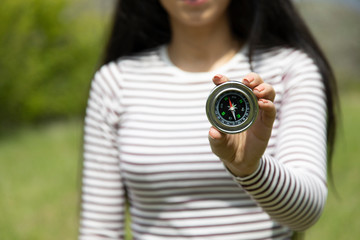 woman hand compass in nature