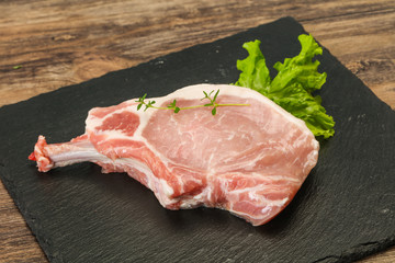 Raw pork bone steak over wooden