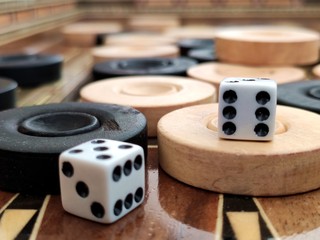 Backgammon with wooden inlay. Wooden backgammon board game of pearl inlaid on brown background.