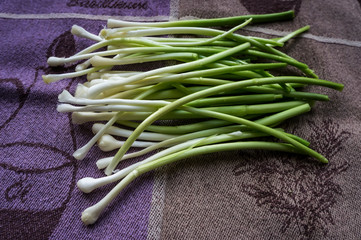 Wild onions cooked for salad are dried on a towel