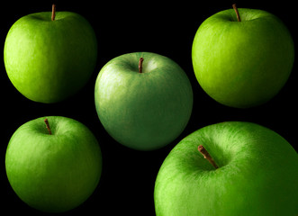 five green bright apples on a black background