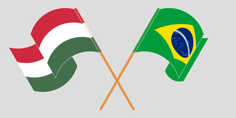 Crossed and waving flags of Hungary and Brazil