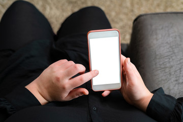 Close up of woman reading news on smart phone at home. Hands texting message or scrolling on social media. Browsing internet, chatting online