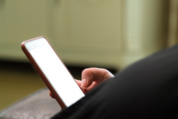 Close up of woman reading news on smart phone at home. Hands texting message or scrolling on social media. Browsing internet, chatting online