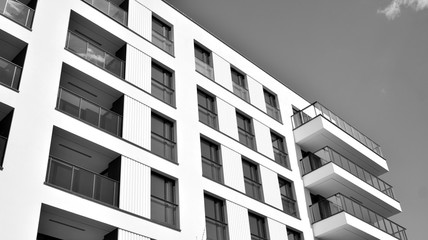 Detail of modern residential flat apartment building exterior. Fragment of new luxury house and home complex. Black and white.