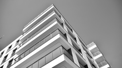 Detail of modern residential flat apartment building exterior. Fragment of new luxury house and home complex. Black and white.