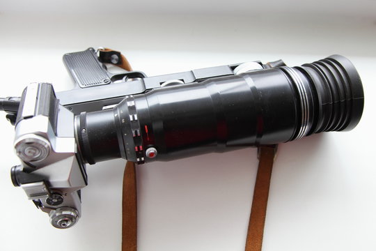 Retro Soviet Photo gun close-up top view - SLR film camera, large telephoto lens on handle