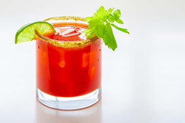 Close up of a cold caesar cocktail or bloody mary on a glass on a white background © oasisamuel