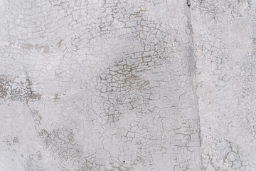 Texture of an old white wall with a lot of cracks