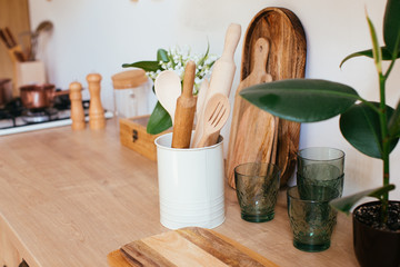 wooden rustic kitchen table. minimalistic interior, utencils on the table