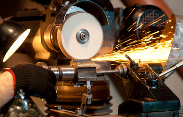 Grinding machine at work. Sparks.