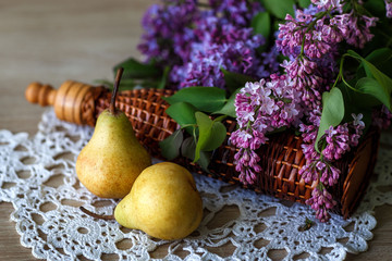 Still life, lilac, pear, rattan bottle
