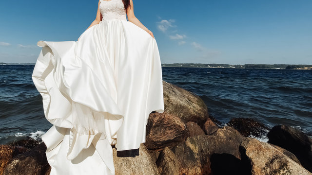 the bride in a wedding dress on sea background.Banner. Place for text.
