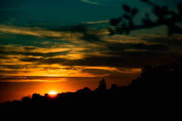 Blue and yellow background with sunset sun, soft focus