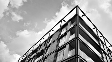 Detail of modern residential flat apartment building exterior. Fragment of new luxury house and home complex. Black and white.