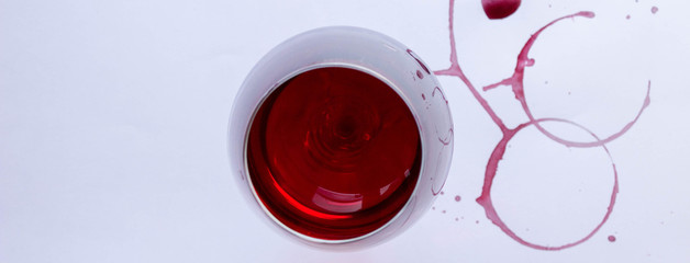 A glass of pink red wine on white background with Traces of wine. Top view. Free copy space.  Concept of organic drinks.