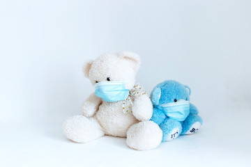 several soft toys in a medical mask on a white background