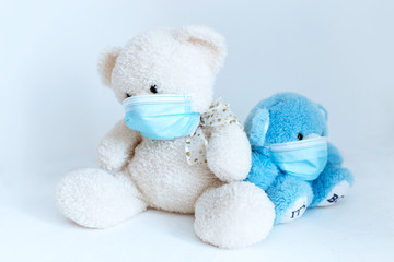 several soft toys in a medical mask on a white background