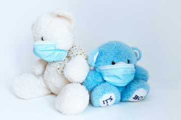 several soft toys in a medical mask on a white background