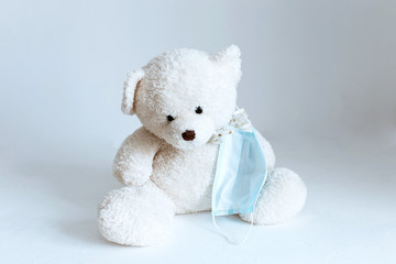 soft toy with a medical mask removed on a white background