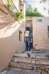 Obraz na płótnie Canvas A young tourist woman wandering through the side streets of Plaka in Athens Greece