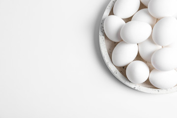 Fresh chicken eggs on white background, top view. Space for text
