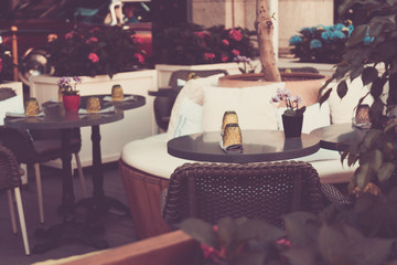 Street cafe in city. Tables of summer cafe on street. Soft focus background.