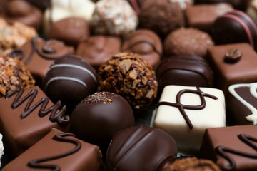 Different delicious chocolate candies as background, closeup
