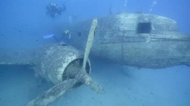 exploring underwater air plane wreck fish around ocean scenery of airplane for scuba divers to discover