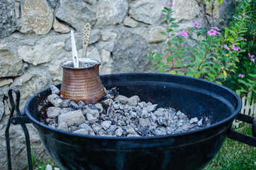 Traditional Turkish coffee cooked on a barbecue.