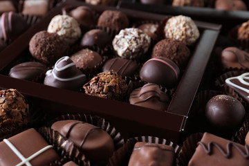 Different tasty chocolate candies as background, closeup