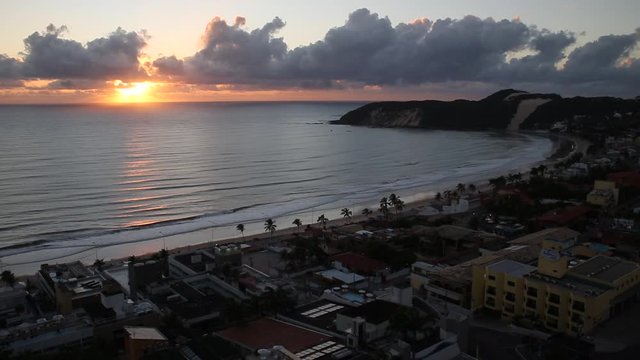 Beautiful aerial view of epic sunrise over the sea, Ponta Negra beach and Natal village skyline in Rio Grande do Norte, Brazil. Concept of summer, travel destinations, vacations, tourism and landscape