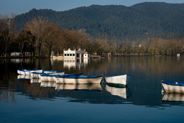 Boats moored on the lake with the mountains in the background