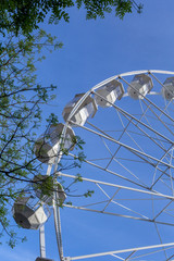 Empty ferris wheel with a blue sky in the background