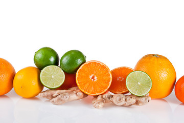 Orange fruits with tangerines, limes, lemons and ginger roots isolated on a white background.