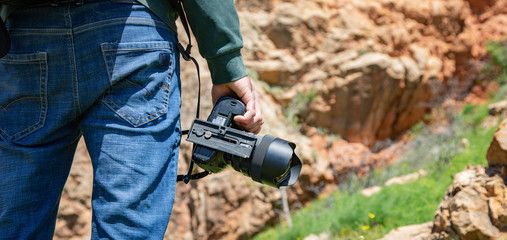 traveler hand photo camera in nature