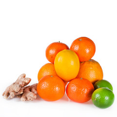 Orange fruits with tangerines, limes, lemons and ginger roots isolated on a white background.