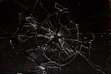 Close up of broken glass with splinters on dark background